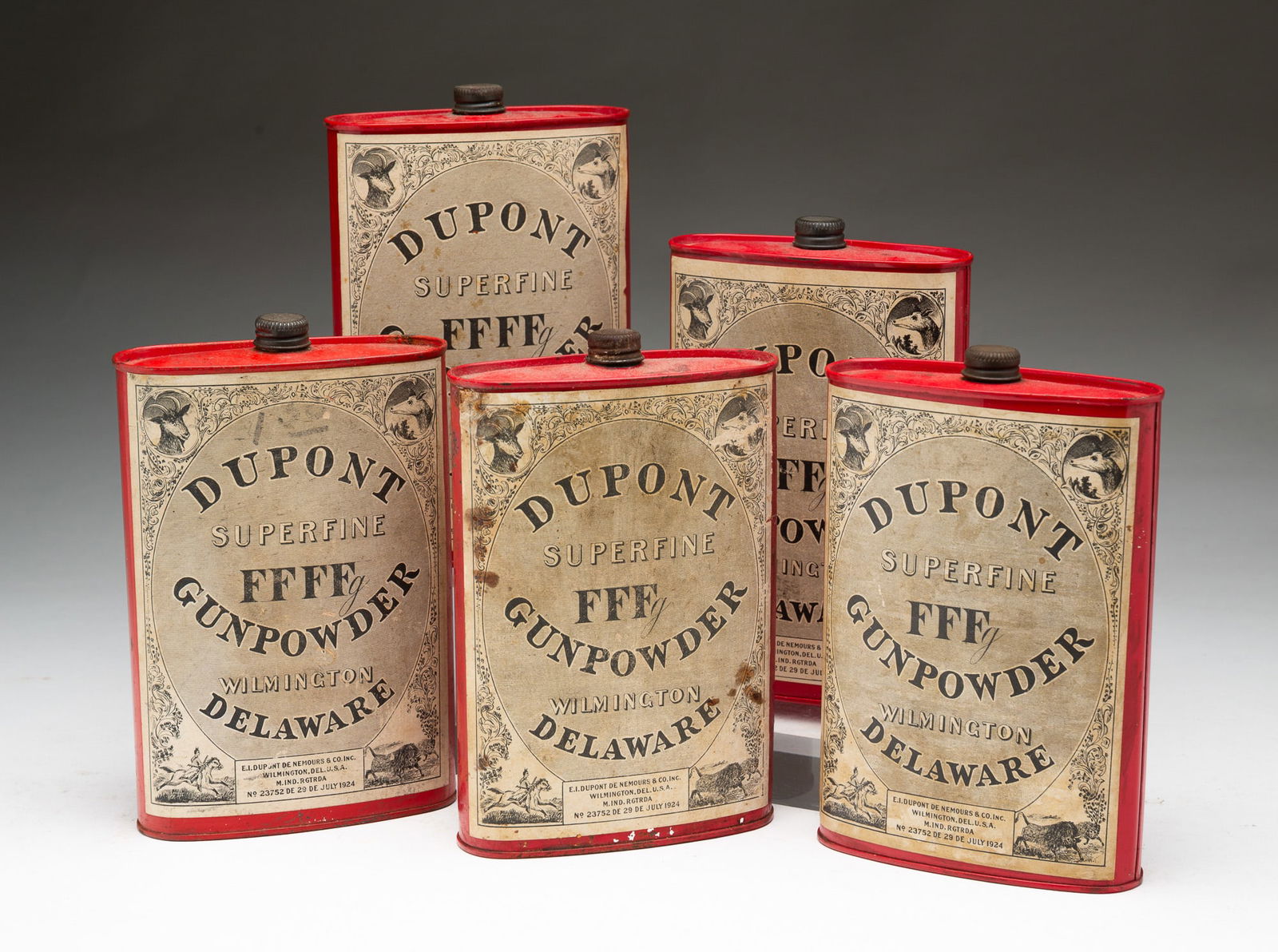 FIVE DUPONT (WILMINGTON, DELAWARE) TIN SUPERFINE GUNPOWDER 1 LB. FLASKS.: E.I. Dupont De Nemours & Co. Inc. (Wilmington, Delaware), Early 20th Century. Tin. Each having a twist-off cap above a flask-shaped body with paper label reading "DUPONT / SUPERFINE / GUNPOWDER / WILM