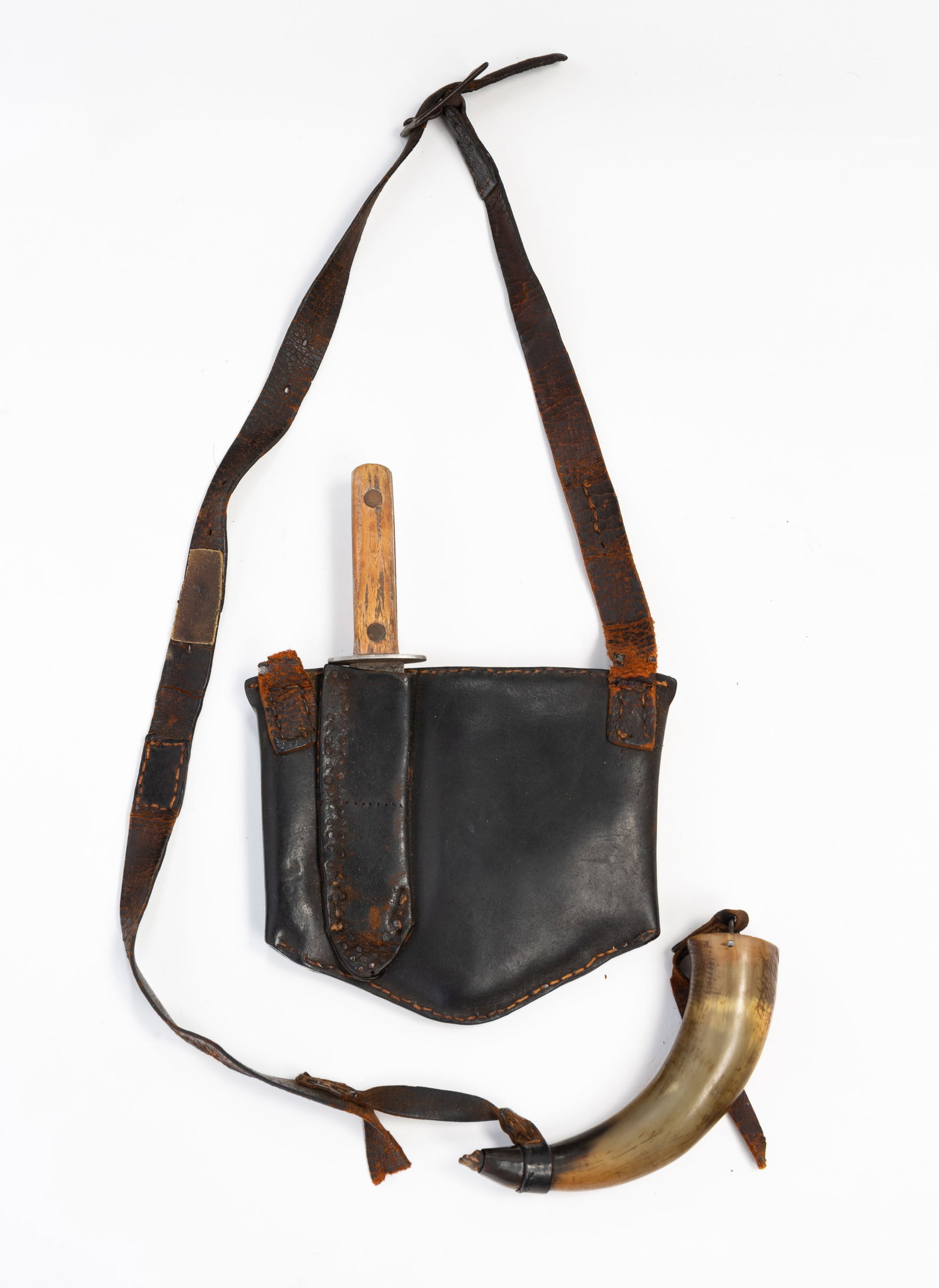 AMERICAN HUNTING POUCH WITH ACCOUTREMENTS.: American, 19th Century. Hand sewn pouch with strap and buckle, knife with horn handle and powder horn. 7"h. 8"w. plus strap.