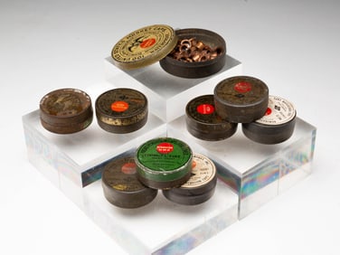 NINE AMERICAN REMINGTON ARMS PERCUSSION RIFLE CAP TINS.