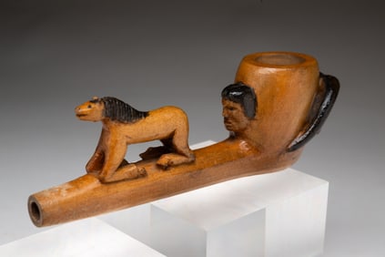 NATIVE AMERICAN CARVED AND PAINT DECORATED WOODEN PIPE.