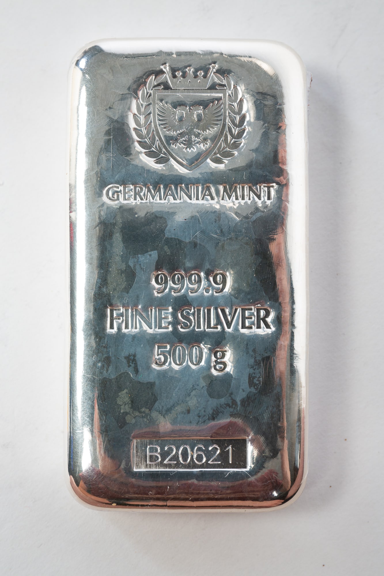 GERMANIA MINT 500G FINE SILVER 999.9 BULLION BAR.: Switzerland, 20th Century. Rectangular form with rounded corners stamped "GERMANIA MINT 999.9 FINE SILVER 500g" and numbered "B20621.*We do not grade or qualify coin condition. Bidder should make thei