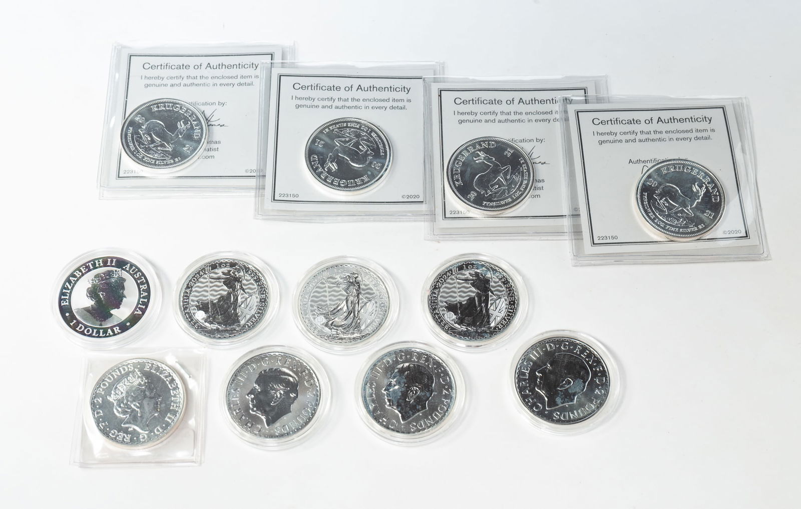 TWELVE ONE OUNCE FINE SILVER COINS.: Contemporary. Two 2023 Charles III 2 pound, one ounce fine 9999 silver coins, four 2024 Charles III 2 pound, one ounce fine 9999 silver coins, 2023 Elizabeth II, 2 pound one ounce fine 9999 silver coi