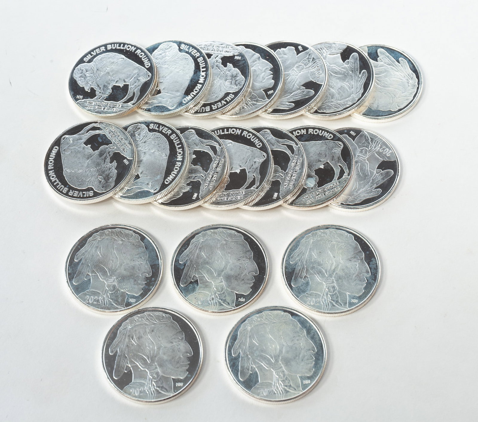 NINTEEN (19) 2022 ONE OUNCE FINE SILVER INDIAN HEAD BULLION ROUNDS.: American, contemporary. Silver bullion rounds resembling a buffalo nickel with an Indian head to front and a buffalo to verso. Minted in one troy ounce of fine silver.*We do not grade or qualify coin