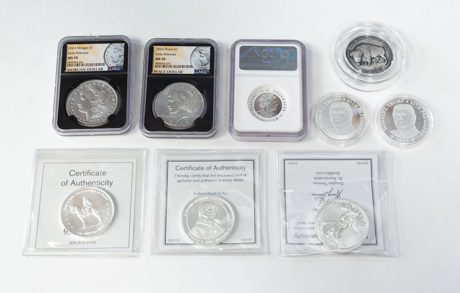 GROUPING OF NINE FINE SILVER COINS.: Contemporary. A 2022 Australia S1 Wedge-Tailed Eagle 1 ounce fine silver coin, a 2023 Morgan $1 coin, 2023 Peace $1 coin, a Oglala Lakota Sioux Nation Indian Sovereign Nation commemorative coin, Gener