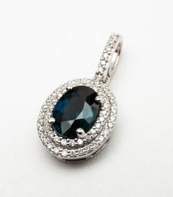 14K WHITE GOLD NATURAL SAPPHIRE AND DIAMOND HALO PENDANT.