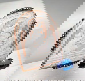 A SHELL CAMEO BROOCH AND A LOOSE TANZANITE.