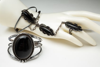 TWO NAVAJO ONYX AND JET CUFF BRACELETS.