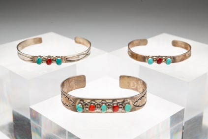 THREE NATIVE AMERICAN W. LONG TURQUOISE AND CORAL CUFF BRACELETS.