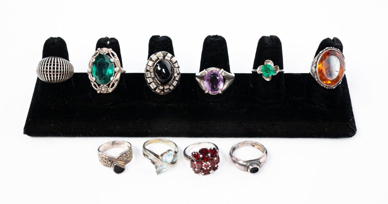 GROUPING OF STERLING SILVER GEMSTONE RINGS.: Contemporary. Ten rings set with amethysts, onyx, garnet, topaz and other stones. Ranging in sizes from 6 to 11.5. Approximately 2.0 ozt.