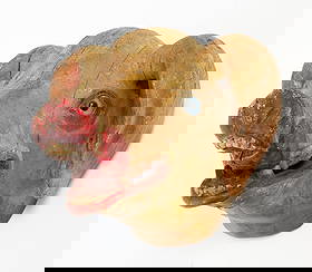 FOLK ART CARVED AND PAINTED PIG HEAD BUTCHER'S TRADE SIGN.: American or European, 19th Century. Wood and composition. The head with glass eyes flanked by floppy ears and continuing to an open mouth with visible teeth and tongue. 15.25"h. 15.25"w. 17"d.Provenan