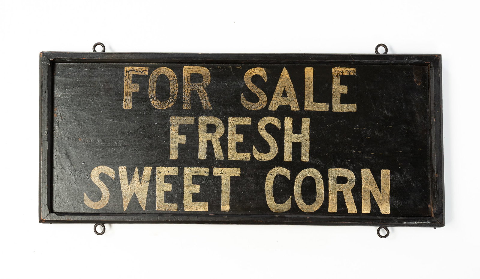 AMERICAN PAINTED "FOR SALE FRESH SWEET CORN" DOUBLE-SIDED TRADE SIGN.: Early 20th Century. Wood. The ebonized, rectangular board has a molded frame and white letters reading "FOR SALE / FRESH / SWEET CORN" on both sides. The top and bottom edges are mounted with ring han