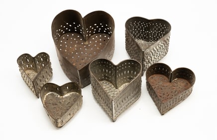 SIX AMERICAN PUNCHED TIN HEART-SHAPED CHEESE MOLDS.