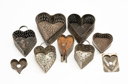 SIX AMERICAN PUNCHED TIN HEART-SHAPED CHEESE MOLDS PLUS MAPLE SUGAR MOLD AND TWO COOKIE CUTTERS.