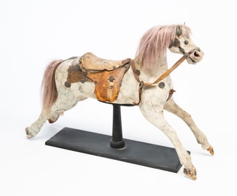 AMERICAN CARVED AND PAINT-DECORATED CHILD'S ROCKING HORSE ON LATER STAND.