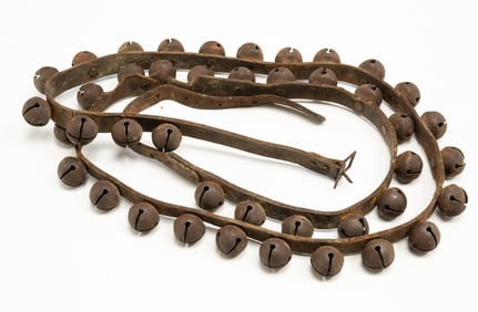 LEATHER STRAP WITH FORTY-TWO METAL SLEIGH BELLS.