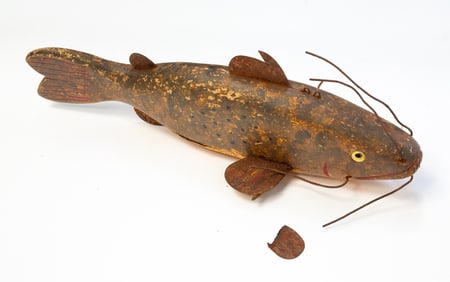 AMERICAN FOLK ART CARVED AND PAINTED CATFISH ICE FISHING DECOY.