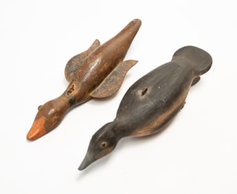 TWO AMERICAN FOLK ART CARVED AND PAINTED DUCK ICE FISHING DECOYS.