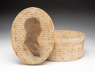 OVAL BANDBOX WITH SILHOUETTE AND HANDWRITTEN LETTERS.