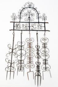 AMERICAN WROUGHT IRON HEARTH WALL RACK WITH MATCHING FORKS.
