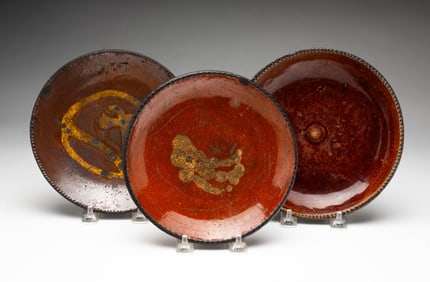 THREE AMERICAN REDWARE PLATES.