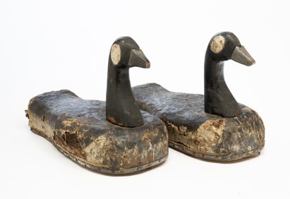PAIR OF AMERICAN FOLKSY CARVED PINE AND OIL CLOTH-LINED CORK CANADIAN GEESE DECOYS.