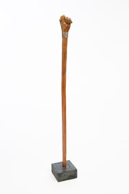 FOLKSY CARVED HARDWOOD AND STERLING-MOUNTED SWAGGER STICK OF CLENCHED FIST.