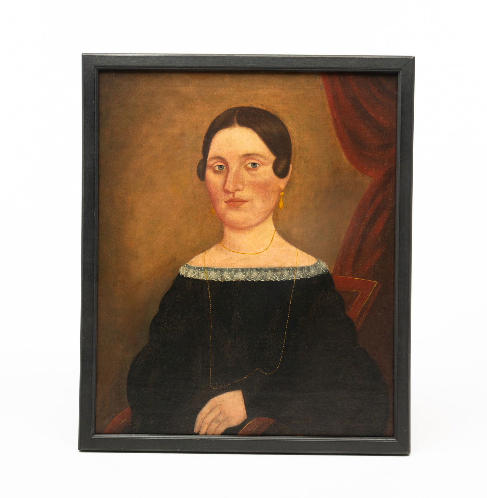 AMERICAN SCHOOL OIL ON CANVAS PORTRAIT OF A LADY.: 19th Century. Oil on canvas. Against a draped background, she is seated in a red armchair, has her hair pulled back, wears an off the shoulder black dress with lace collar, and wears a long gold neckl