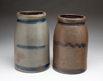 TWO AMERICAN STONEWARE CANNING JARS WITH COBALT STRIPES.