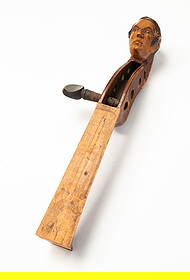 AMERICAN CARVED AND PAINTED TIGER MAPLE VIOLIN HEAD.: Mid-19th Century. Nicely carved in the form of a man's head with dark hair and sideburns, with illegible writing in pencil on the neck, retaining original finish. 9.5"l.Provenance: Meander Auctions (M