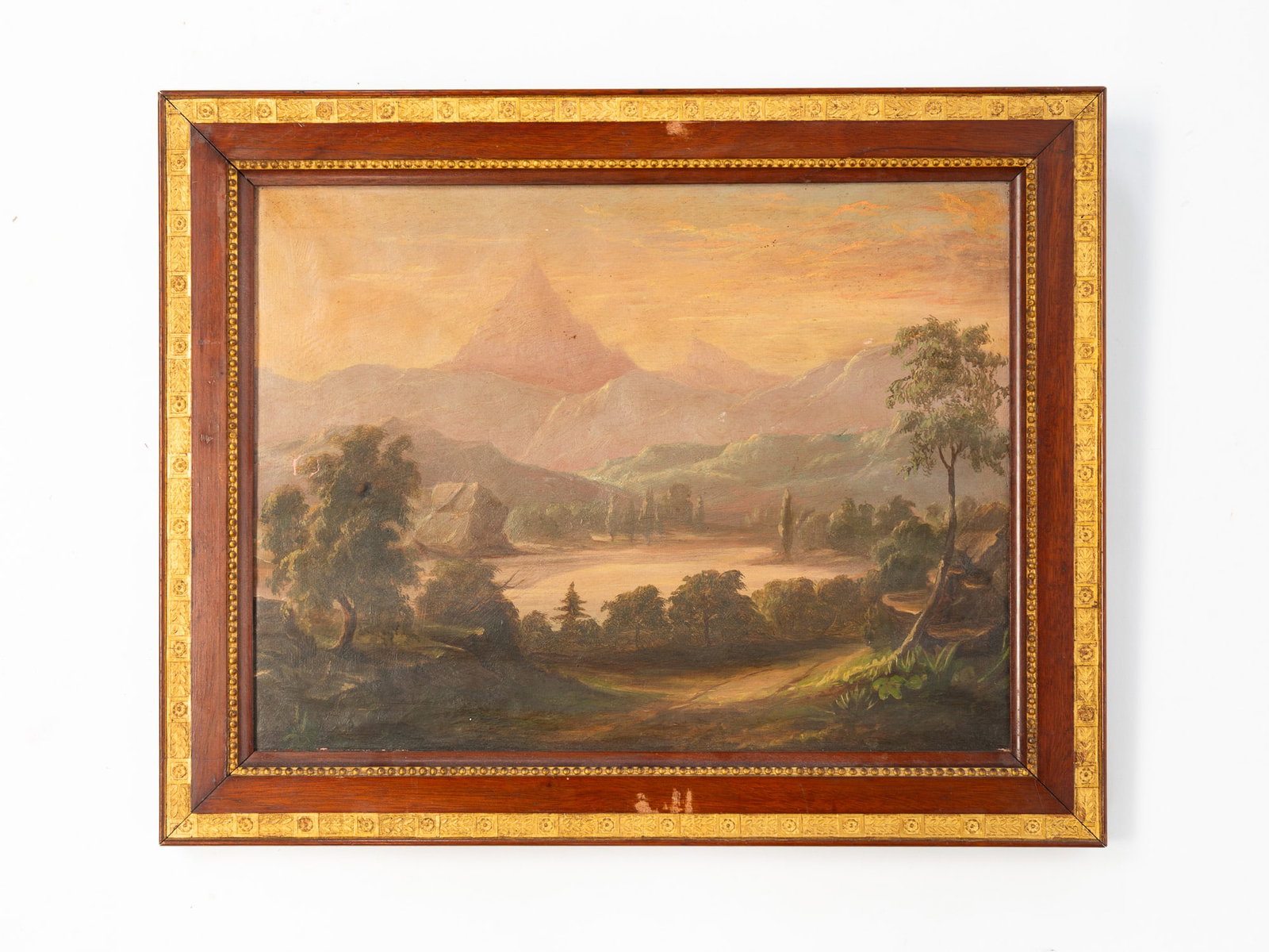 HUDSON RIVER SCHOOL OIL ON CANVAS LANDSCAPE.: Mid-19th Century. Depicting a landscape scene of a river with trees and mountains in the distance. 12.5"h. 16.5"w. In a decorative wood and gilt wood frame, 16"h. 10"w.Provenance: From the Collection 
