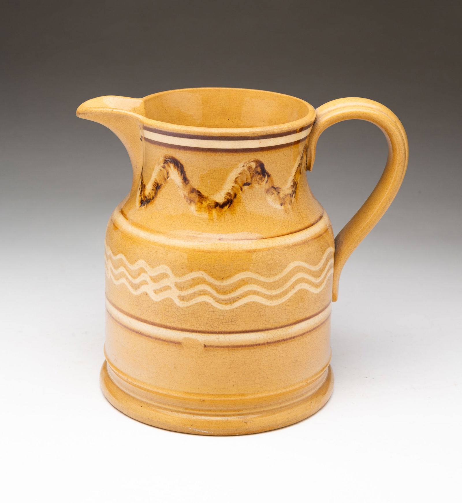YELLOWWARE PITCHER WITH MOCHA EARTHWORM DECORATION. (1 of 3)