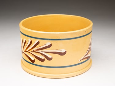 YELLOWWARE CANISTER WITH MOCHA DECORATION.