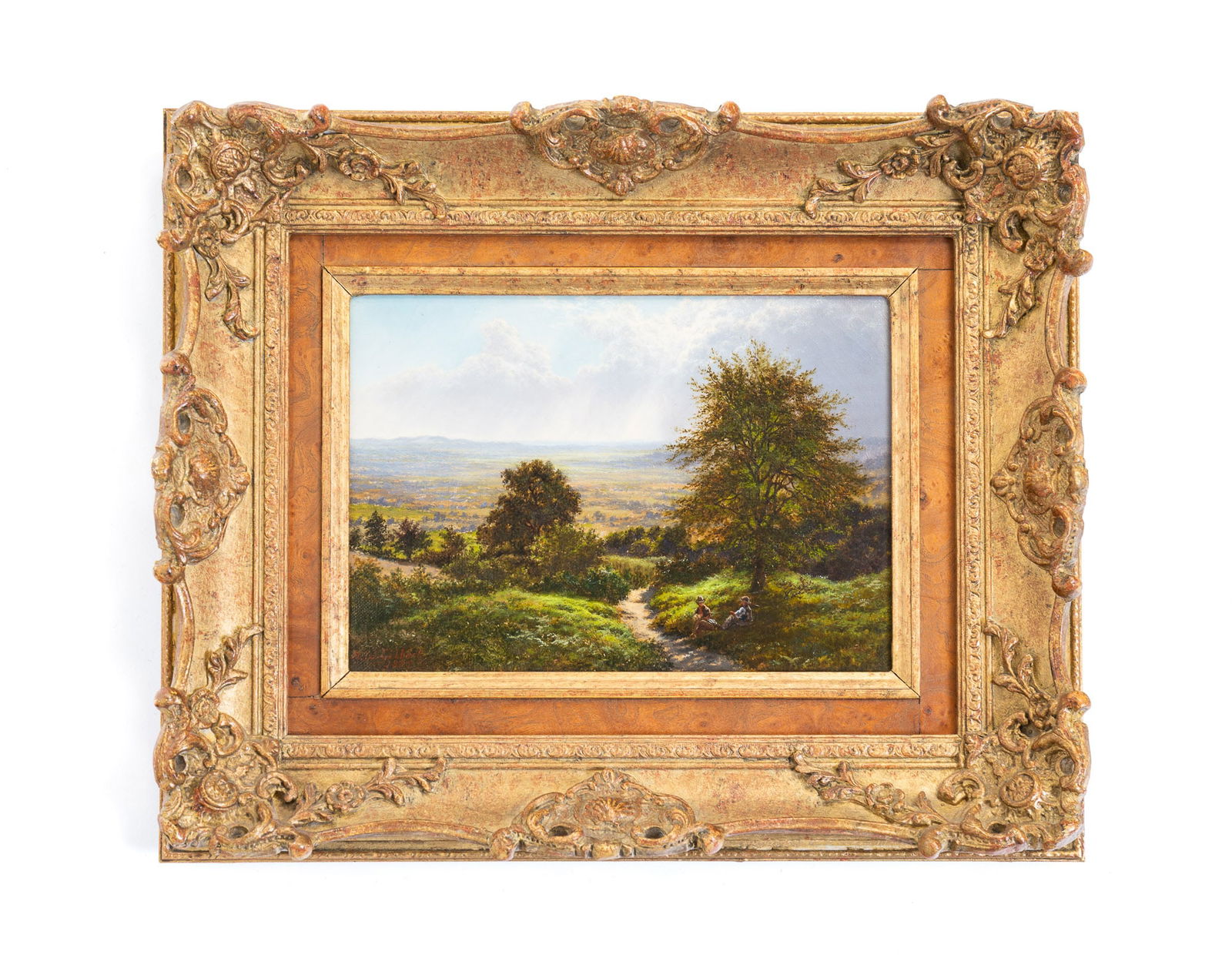 HORACE WALTER GILBERT (BRITISH, 1855-1928) "A PASSING SHOWER" OIL ON CANVAS.: England, dated 1885. Oil on canvas. View of two figures lounging under a tree on a hillside with a view of an expansive valley beyond, Signed "H. W. Gilbert 1885" at lower left. English labels on vers