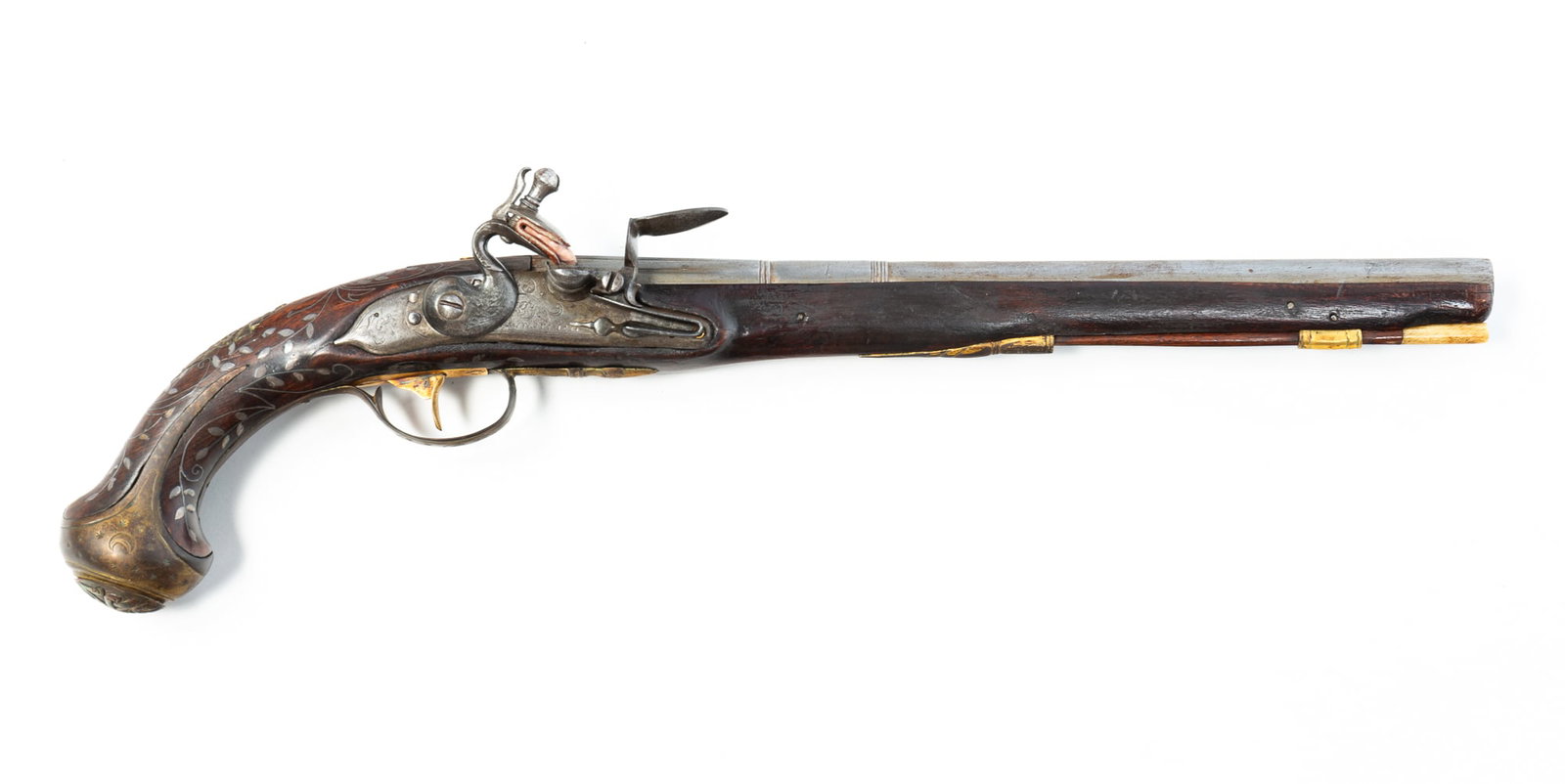 ITALIAN TRADE FLINTLOCK PISTOL.: Late 18th Century. Round smooth bore barrel, silver inlaid stock, engraved lock, brass embossed butt cap. Engraved on top of barred LAZRAD IAZARI. 19"l.Provenance: From the Lifetime Collection of the 