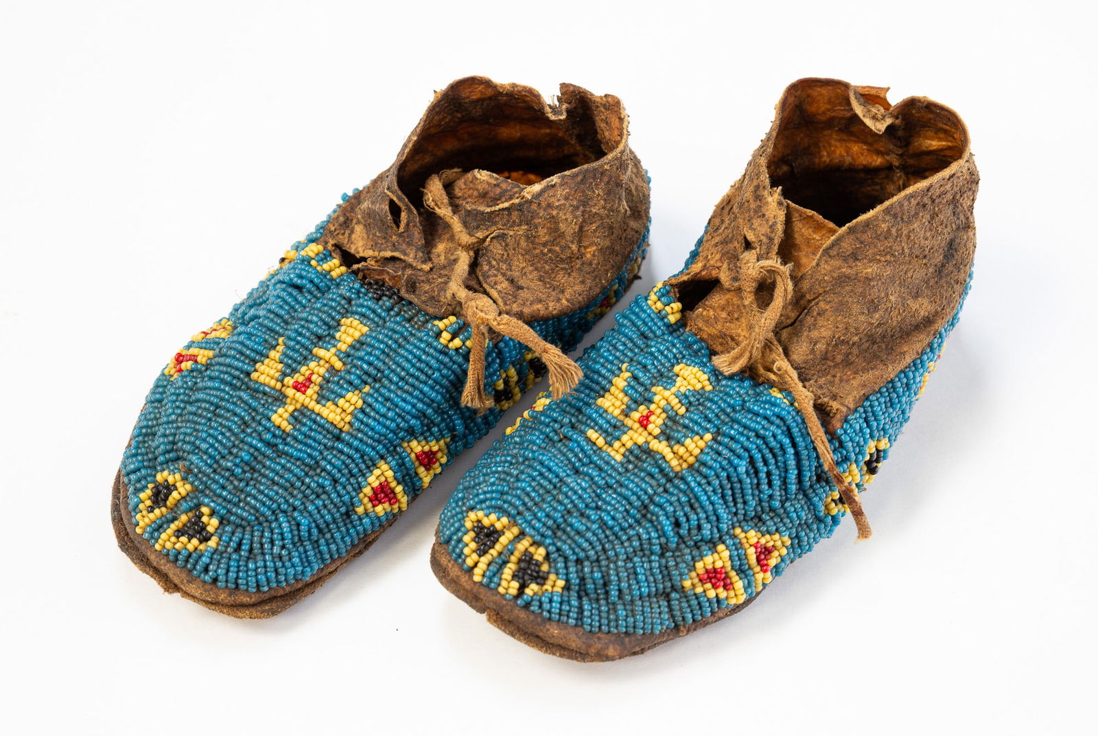 PAIR OF PLAINS CHILD'S BEADED HIDE MOCCASINS. (1 of 3)