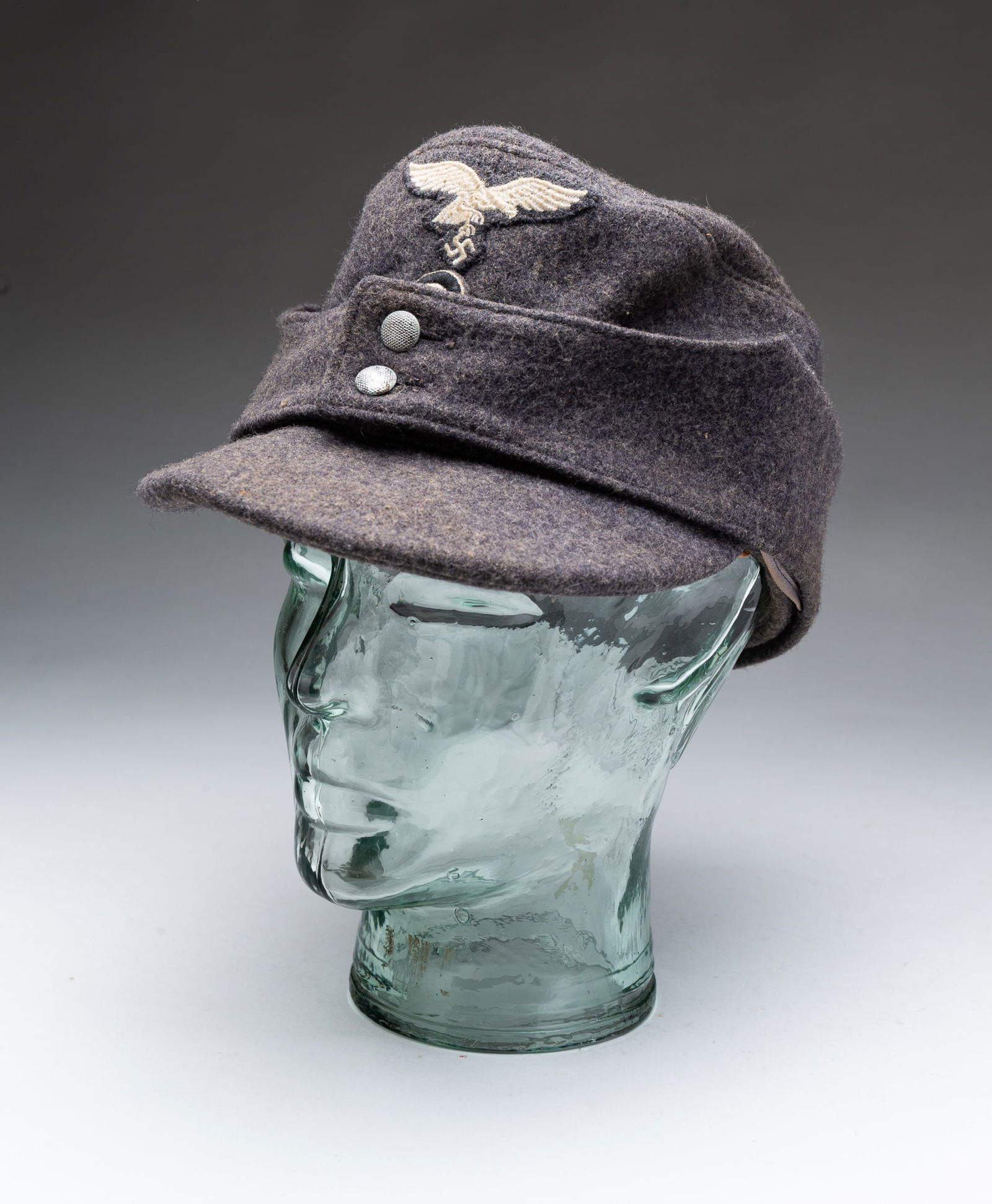 GERMAN ARMY FIELD CAP.: Circa 1940. Gray wool, eagle and swastika and army bullseye patches.Provenance: From the Lifetime Collection of the late Ken Hanna (Chester, New Jersey).NOTE: This item does not include the mannequin
