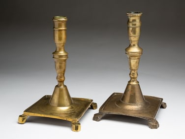 TWO SPANISH BRASS SQUARE BASE CANDLESTICKS.