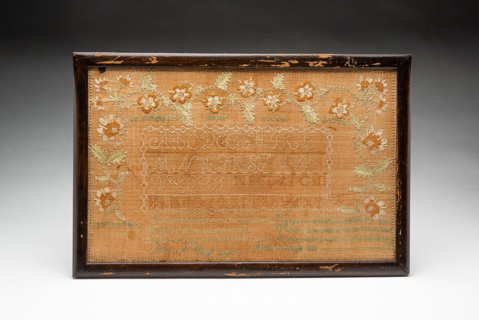 MARY NELSON BRIGGS (SCOTTISH, B. 1801) NEEDLEWORK SAMPLER, DATED 1812.: Colored thread on linen. Rows of alphabet and poetic verse surrounded by well stitched flower and leaf border. Bottom verse reads "Jesus permit Thy gracious name to stand / As the first effort of an i