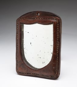 MINIATURE AMERICAN LEATHER SHIELD-FORM MIRROR.