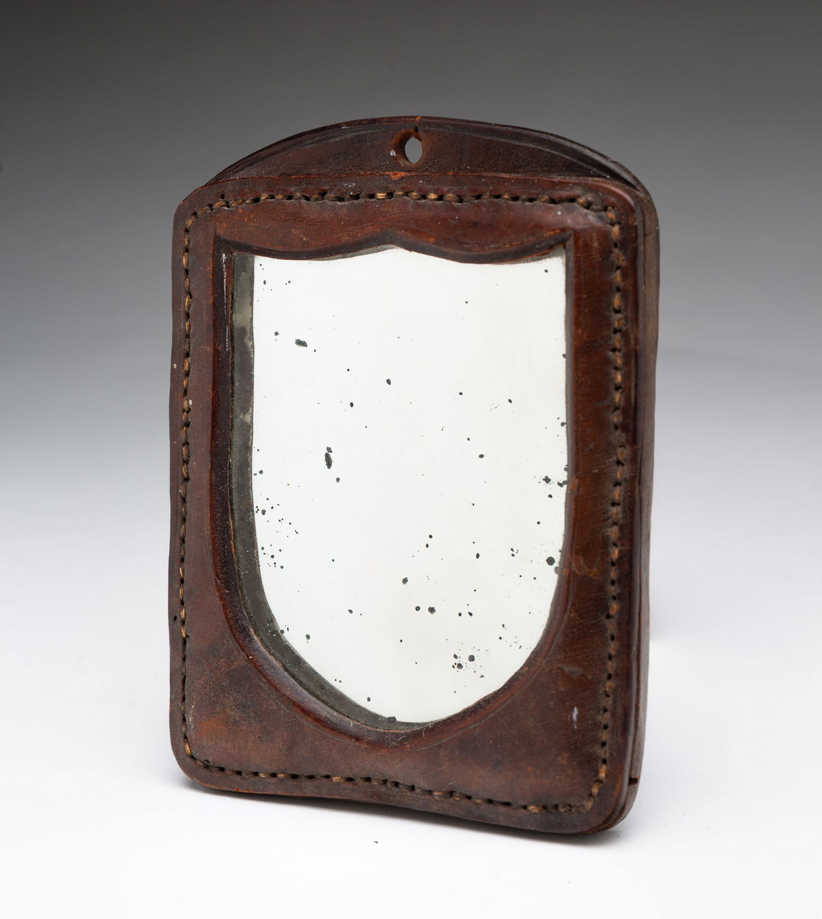 MINIATURE AMERICAN LEATHER SHIELD-FORM MIRROR. (1 of 3)