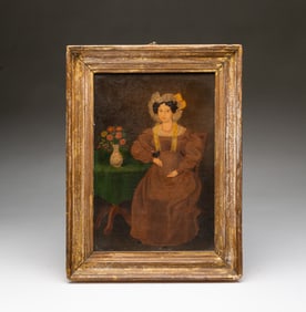 AMERICAN SCHOOL FOLKSY OIL ON BOARD PORTRAIT OF A WOMAN SITTING AT A TABLE.