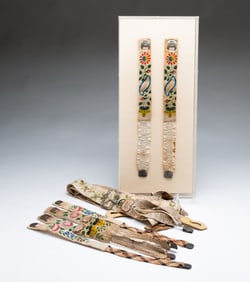 GROUP OF THEOREM-PAINTED AND STENCILED GARTERS WITH EMBROIDERED SUSPENDERS.