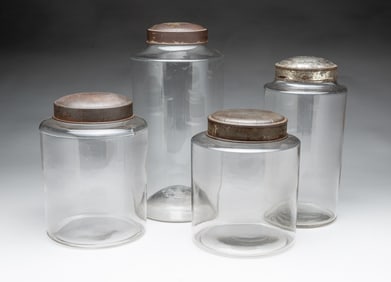 FOUR AMERICAN TIN-LIDDED GLASS GRADUATED CANISTERS.