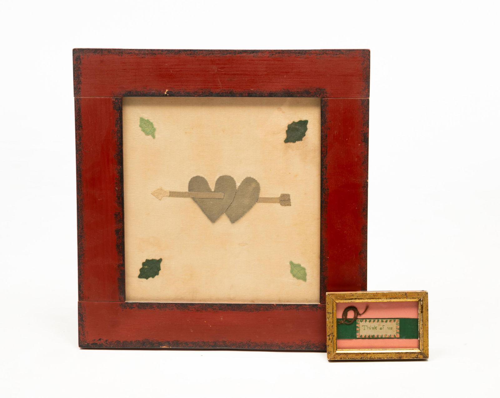 TWO AMERICAN SCHOOL FOLK ART LOVE TOKENS OR VALENTINES, ONE WITH KNOTTED HAIR.: Mid-19th Century. One a collage of a hair knot with a Berlin sampler punched paper message reading "Think of me" on a green ribbon, in a giltwood frame. Frame, 3.55"h. 5"w. The other made of fabric wi