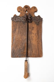 RARE WROUGHT IRON-MOUNTED AND CARVED WOOD BREAD CUTTING BOARD OR BROTSCHNEIDEBRETT, DATED 1763.