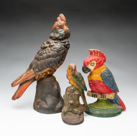 THREE AMERICAN PAINTED CAST IRON PARROT DOORSTOPS.