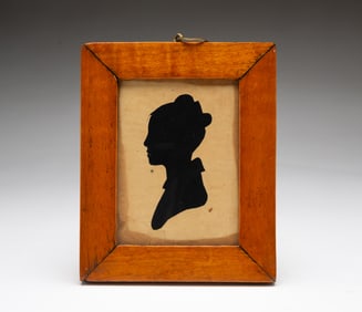 AMERICAN SCHOOL HOLLOW-CUT SILHOUETTE PORTRAIT OF JANE COMFORT IN A TIGER MAPLE FRAME.