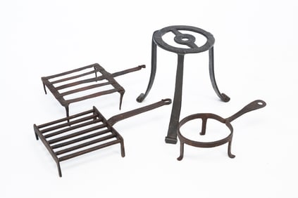 FOUR AMERICAN WROUGHT IRON TRIVETS.