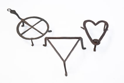 THREE AMERICAN WROUGHT IRON TRIVETS.
