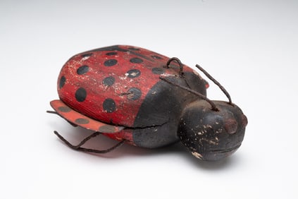 AMERICAN FOLK ART CARVED AND PAINTED LADYBUG ICE FISHING DECOY.